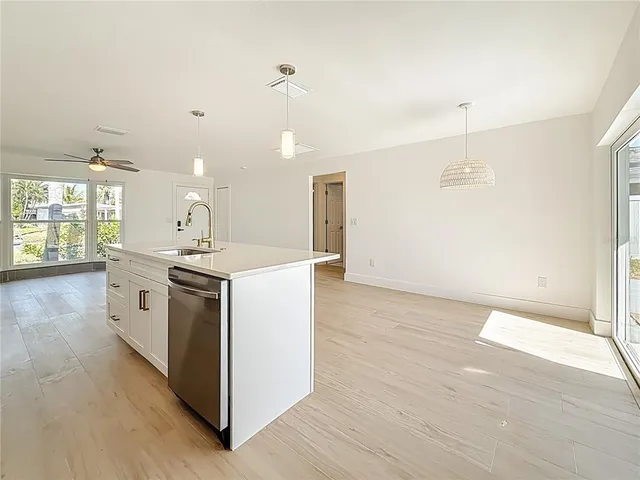 a kitchen with a sink and wooden floor