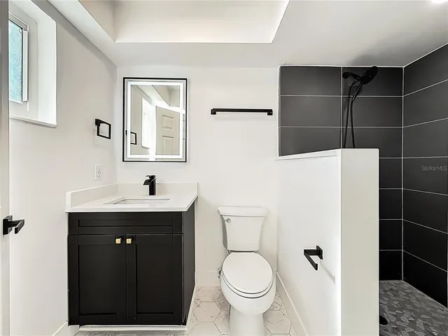 a bathroom with a sink toilet and shower