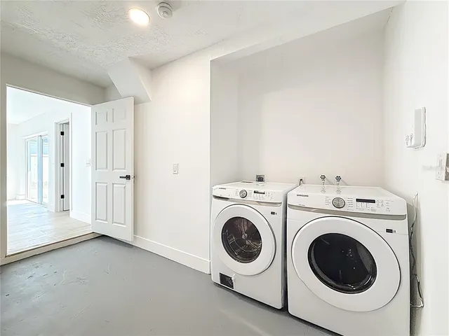 a view of a storage & utility room with dryer and washer