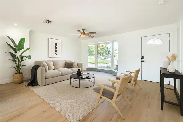 a living room with furniture and a large window