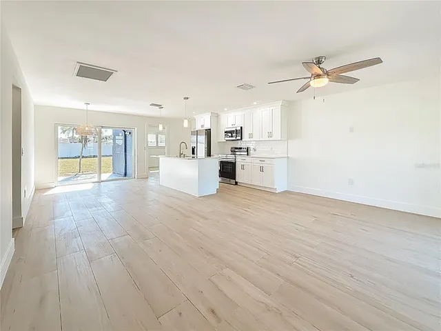 a view of a kitchen with a dishwasher and wooden floor