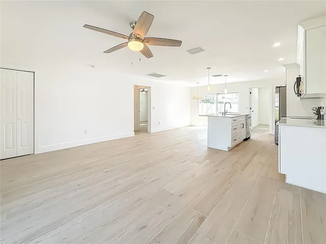 a view of kitchen and hall with wooden floor