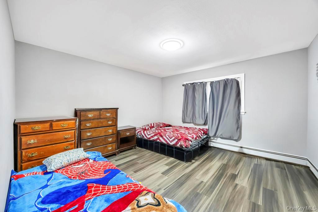 55 Amityville Road Melville, NY 11747 - Photo 11 of 21 a bedroom with a bed and a dresser