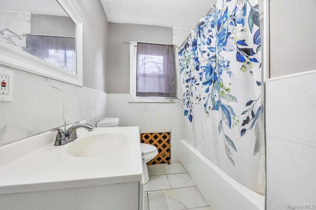 55 Amityville Road Melville, NY 11747 - Photo 12 of 21 a bathroom with a sink and a bathtub