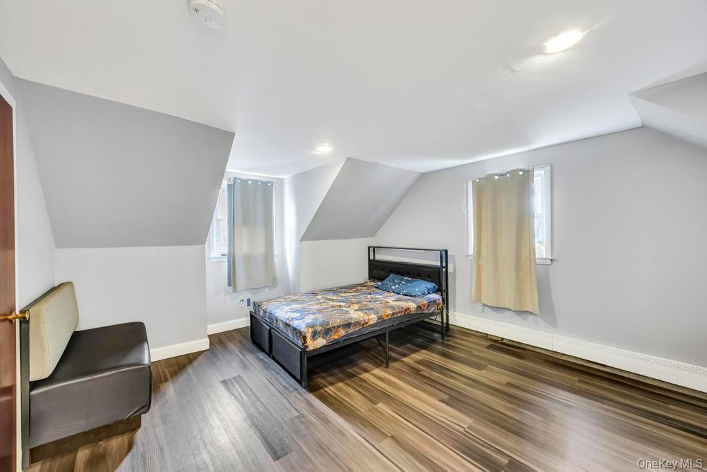 55 Amityville Road Melville, NY 11747 - Photo 13 of 21 a bedroom with two beds and a chair