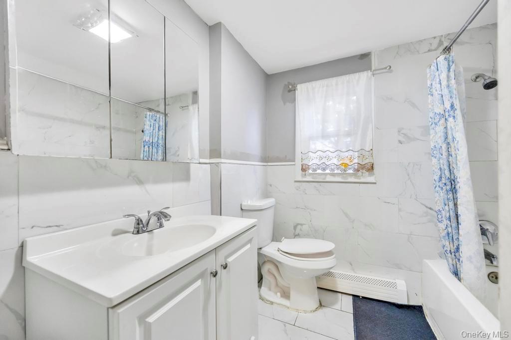 55 Amityville Road Melville, NY 11747 - Photo 14 of 21 a bathroom with a sink toilet and shower