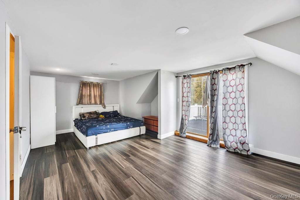55 Amityville Road Melville, NY 11747 - Photo 15 of 21 a living room with furniture and a wooden floor