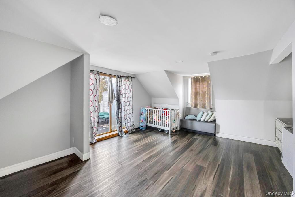55 Amityville Road Melville, NY 11747 - Photo 16 of 21 a living room with furniture and a wooden floor
