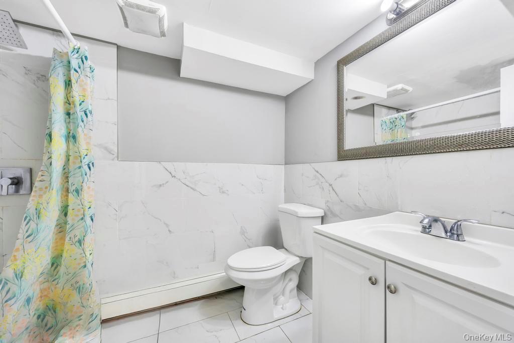 55 Amityville Road Melville, NY 11747 - Photo 18 of 21 a bathroom with a sink and a mirror