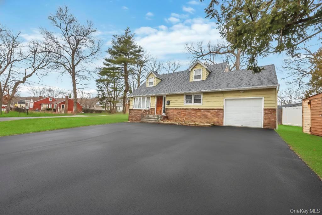 55 Amityville Road Melville, NY 11747 - Photo 2 of 21 a front view of a house with a yard and garage