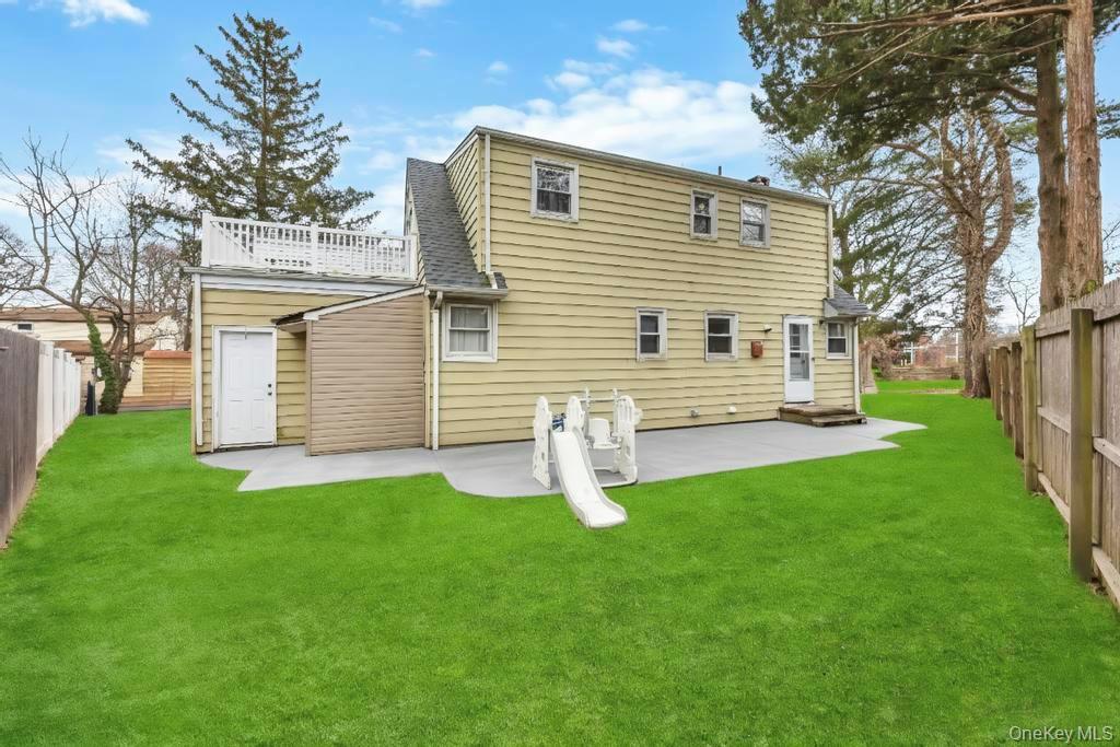 55 Amityville Road Melville, NY 11747 - Photo 4 of 21 a front view of a house with garden