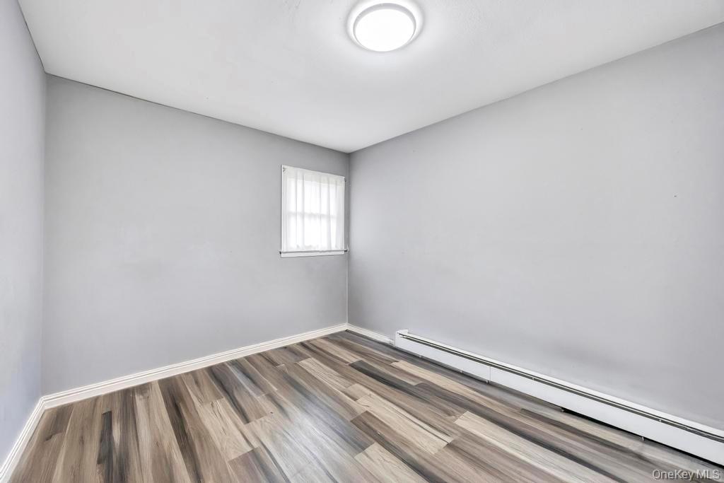 55 Amityville Road Melville, NY 11747 - Photo 10 of 21 a view of a room with wooden floor and windows