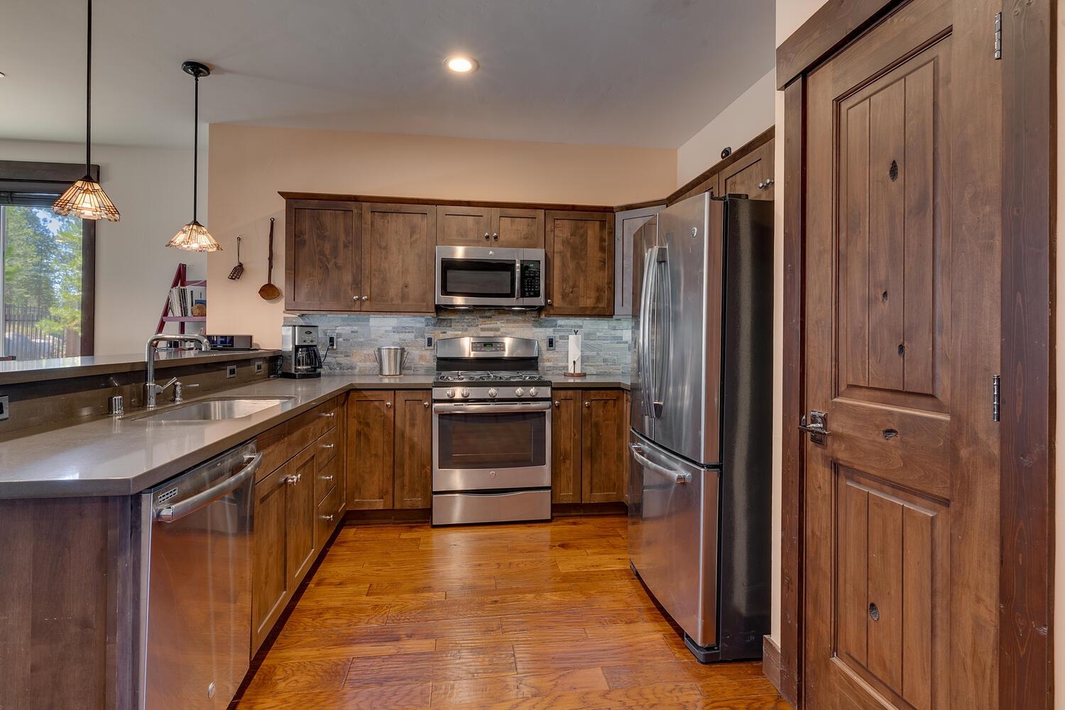 11541 Dolomite Way, Unit 3 Truckee, CA 96161 - Photo 3 of 28 a kitchen with stainless steel appliances granite countertop a refrigerator a sink dishwasher a stove and a microwave