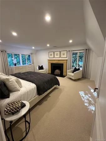 a spacious bedroom with a bed a couch and a window