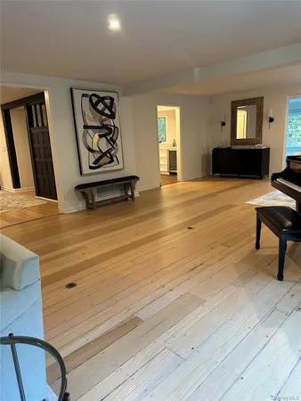 a view of a bedroom with furniture and window