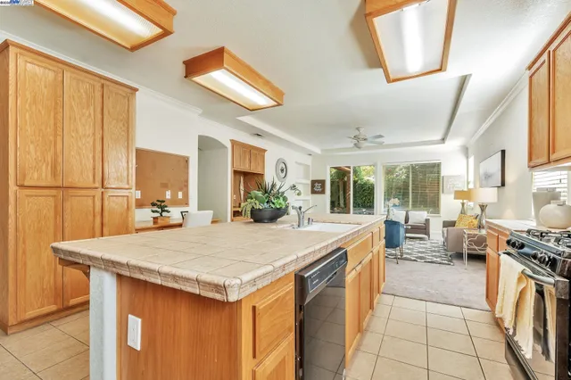 a large kitchen with granite countertop a stove and a sink
