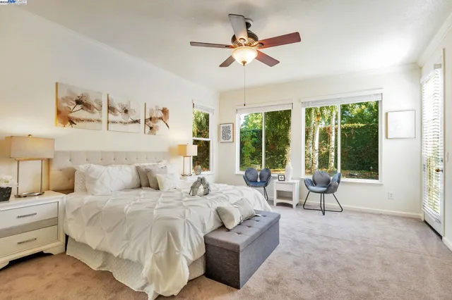 a spacious bedroom with a large bed and a large window