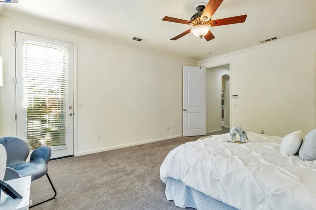 a bedroom with a bed and chair