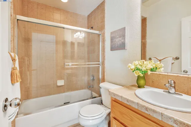 a bathroom with a sink mirror toilet and bathtub