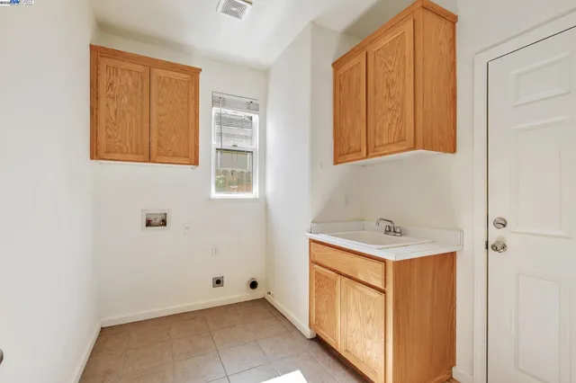 a utility room with a sink a washer and dryer