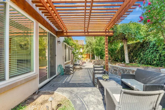 a view of patio with couple of chairs