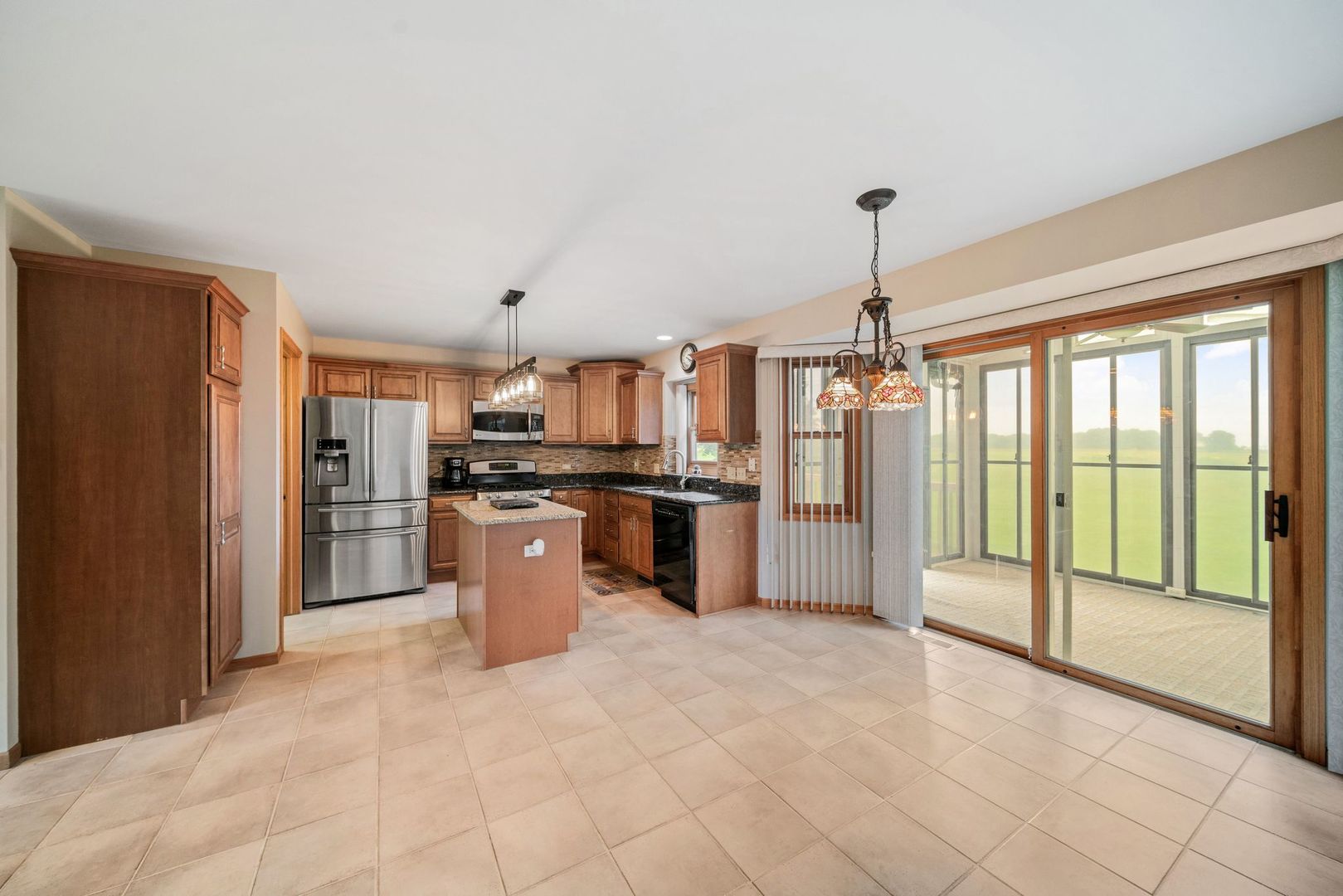 1609 Elm Street Spring Grove, IL 60081 - Photo 7 of 26 a kitchen with stainless steel appliances granite countertop a refrigerator and a sink