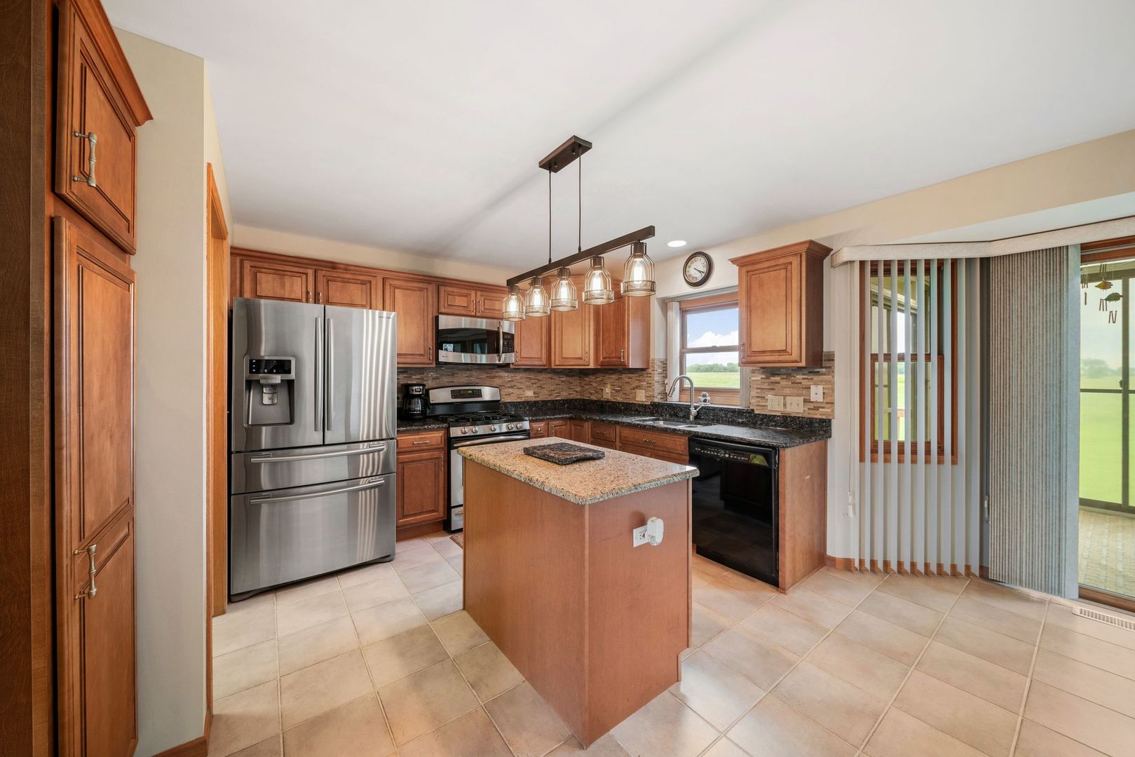 1609 Elm Street Spring Grove, IL 60081 - Photo 8 of 26 a kitchen with stainless steel appliances granite countertop a refrigerator a oven a sink and a stove