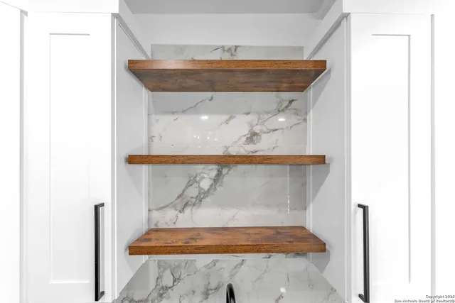 a kitchen with cabinets and stainless steel appliances