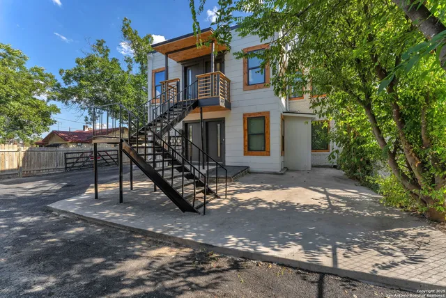 a front view of a house with yard and trees