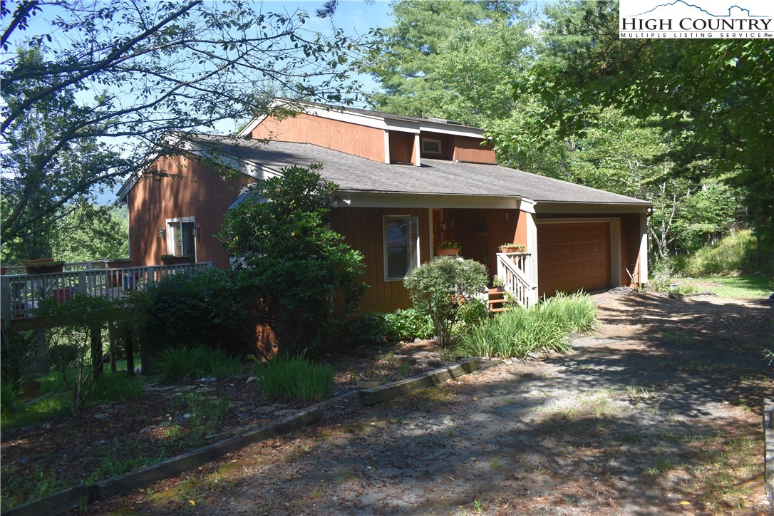 592 River Hills Road Lansing, NC 28643 - Photo 1 of 36 a front view of a house with garden