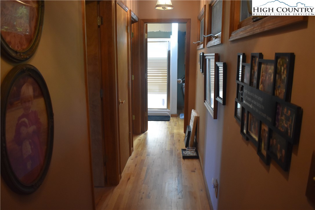 592 River Hills Road Lansing, NC 28643 - Photo 34 of 36 a view of a hallway with wooden floor and staircase