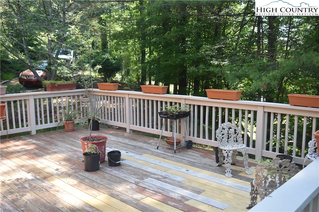 592 River Hills Road Lansing, NC 28643 - Photo 36 of 36 a view of balcony with wooden floor and outdoor seating