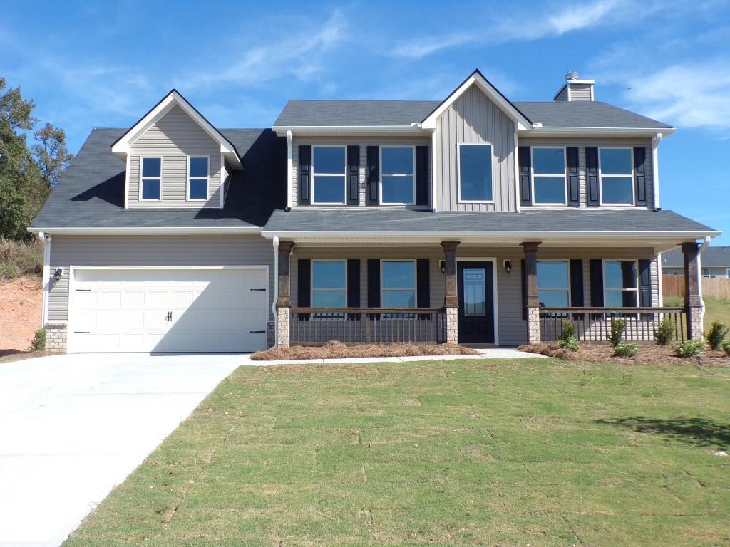 a front view of a house with yard and porch