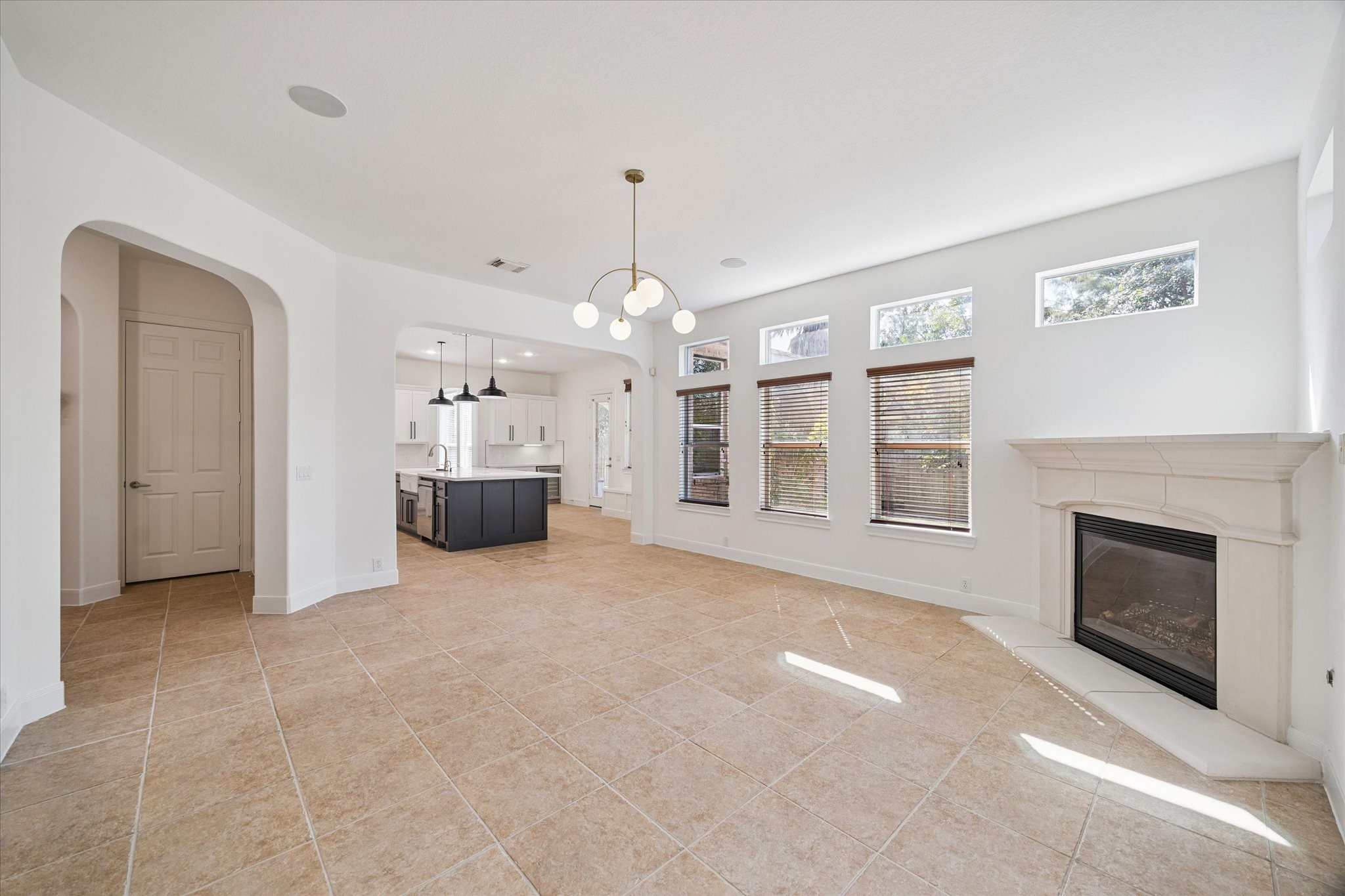 7211 Diamond Falls Lane Spring, TX 77389 - Photo 11 of 29 Open-concept family room with fireplace and abundant windows leading into the kitchen.