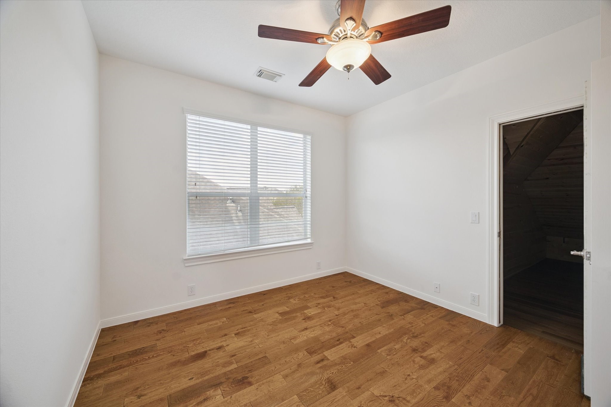 7211 Diamond Falls Lane Spring, TX 77389 - Photo 21 of 29 Light-filled bedroom with ceiling fan and closet access to bonus space.