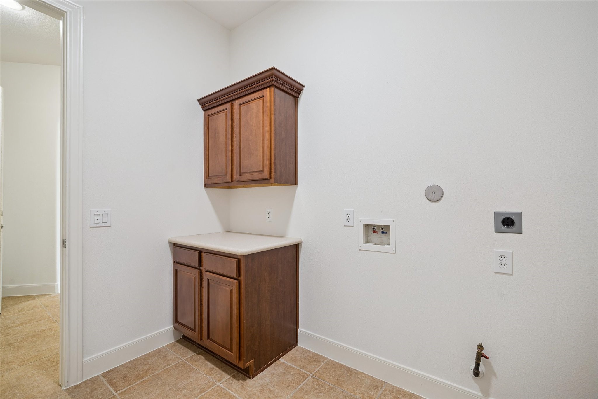 7211 Diamond Falls Lane Spring, TX 77389 - Photo 26 of 29 Convenient laundry area with cabinetry and folding counter.