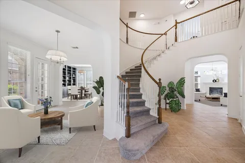 a living room with furniture and a chandelier