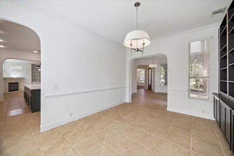 a view of a room with a large mirror and furniture
