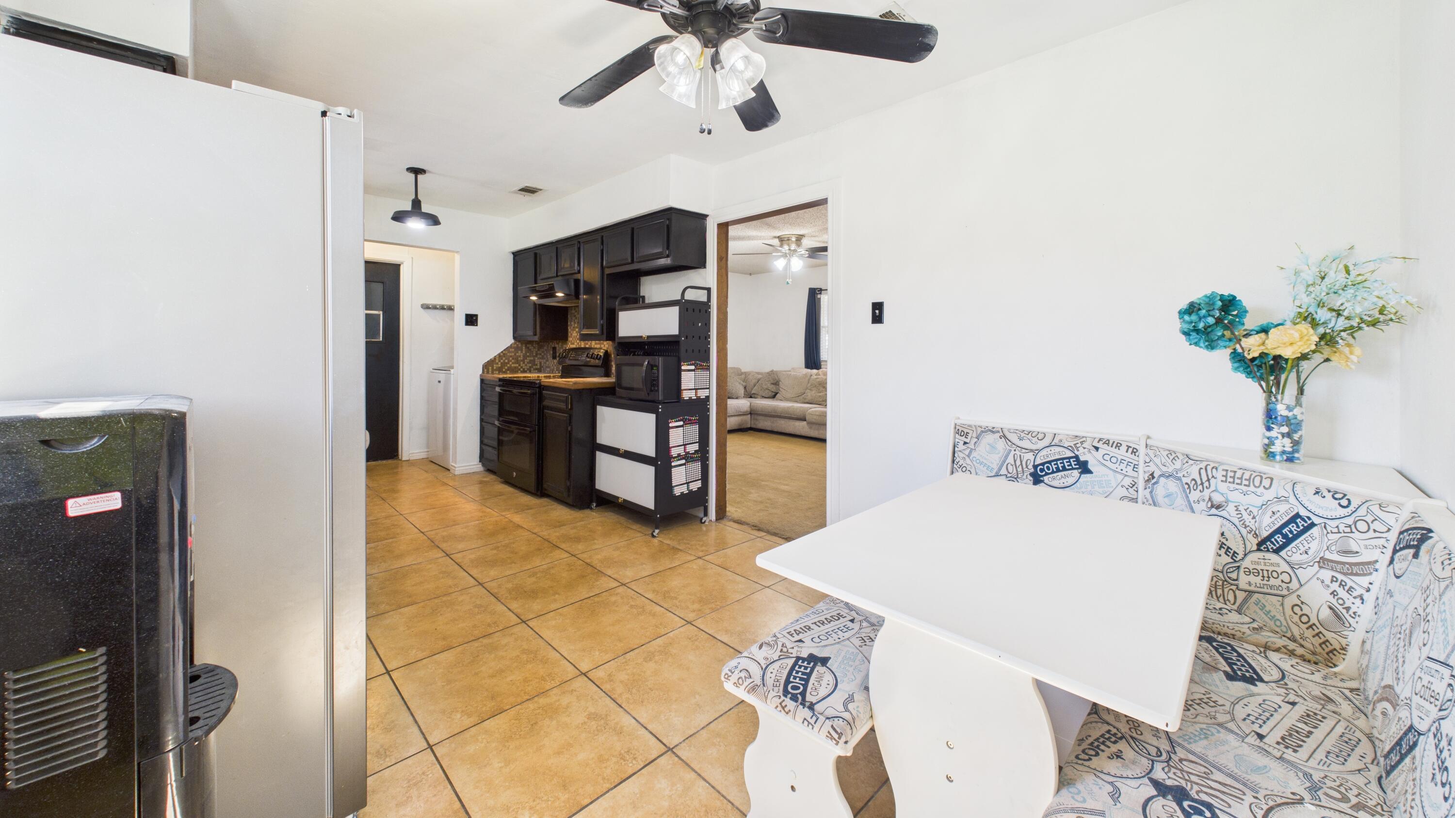 5431 34th Street Lubbock, TX 79407 - Photo 11 of 22 a living room with stainless steel appliances furniture a chandelier and a view of kitchen
