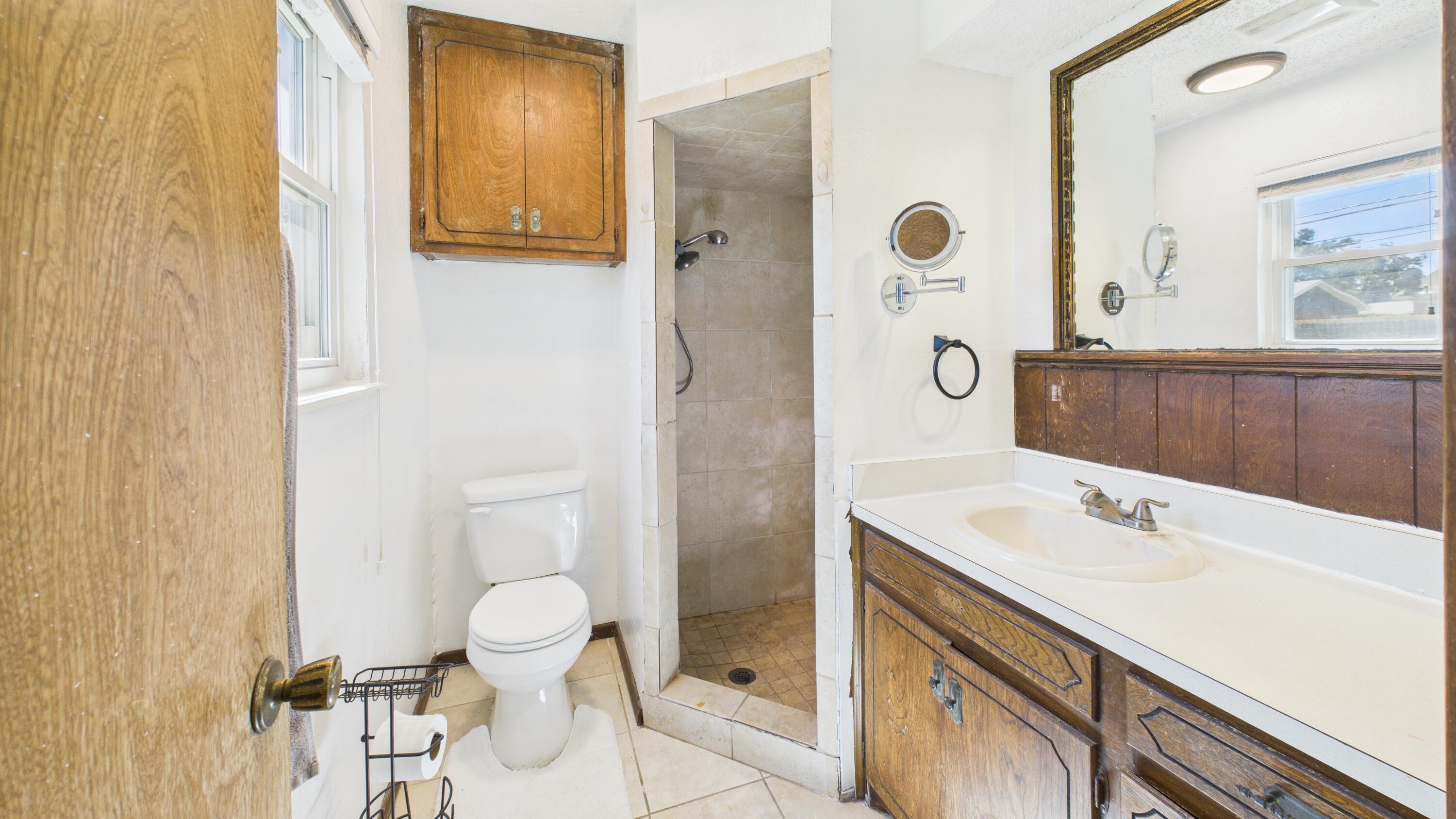 5431 34th Street Lubbock, TX 79407 - Photo 19 of 22 a bathroom with a sink and a mirror