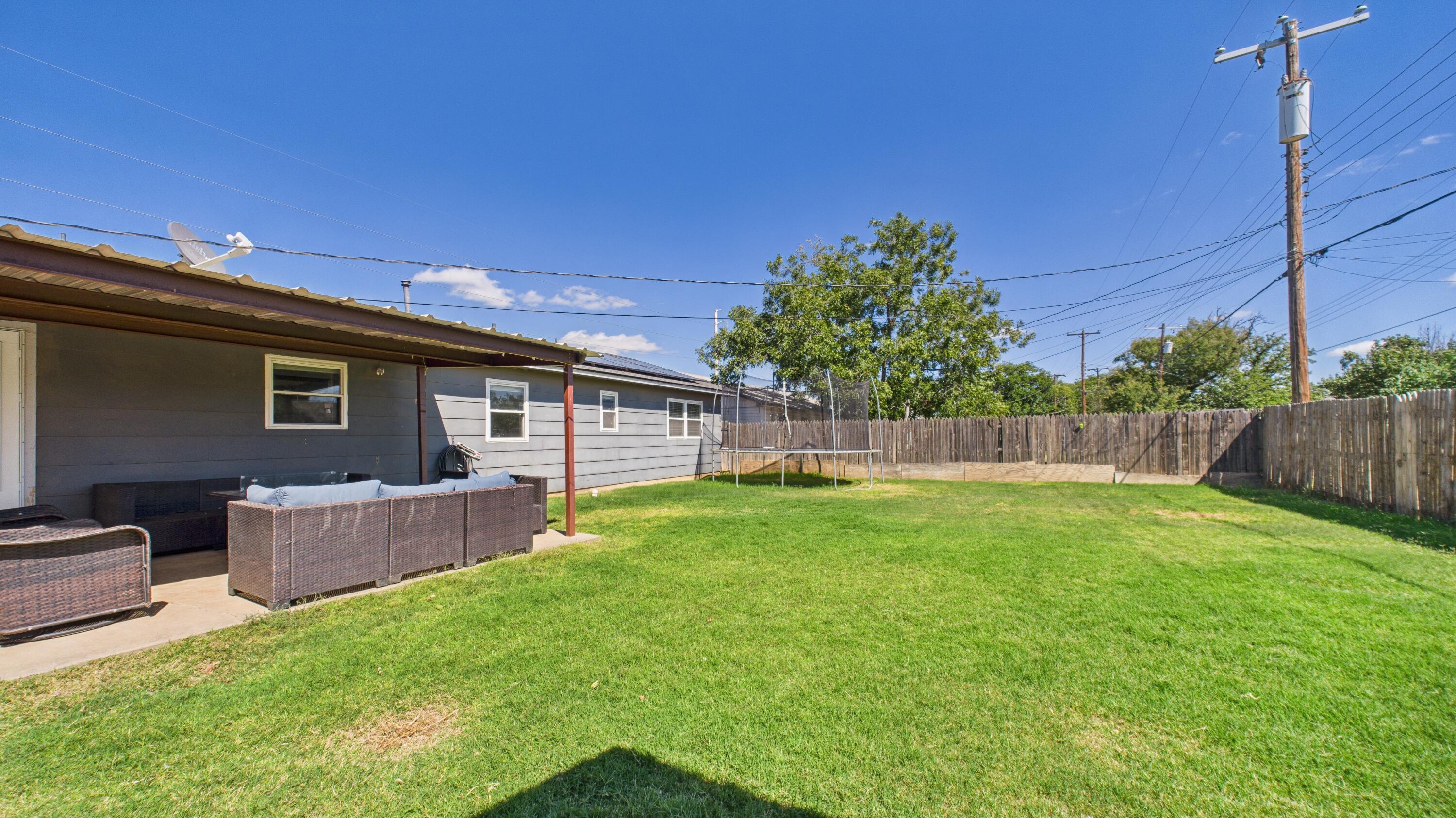5431 34th Street Lubbock, TX 79407 - Photo 21 of 22 a backyard of a house with deck and furniture