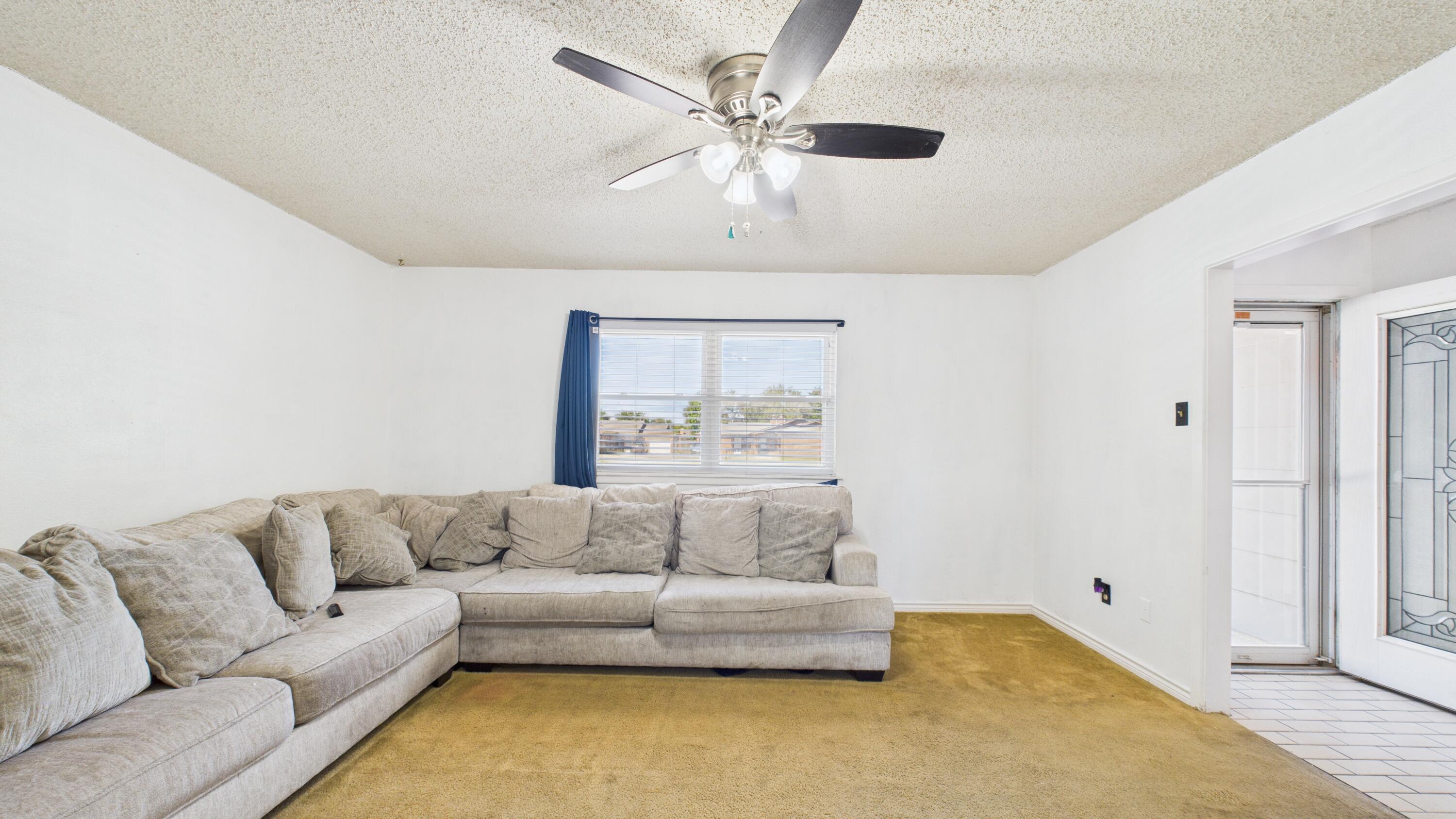 5431 34th Street Lubbock, TX 79407 - Photo 5 of 22 a living room with furniture and a couch