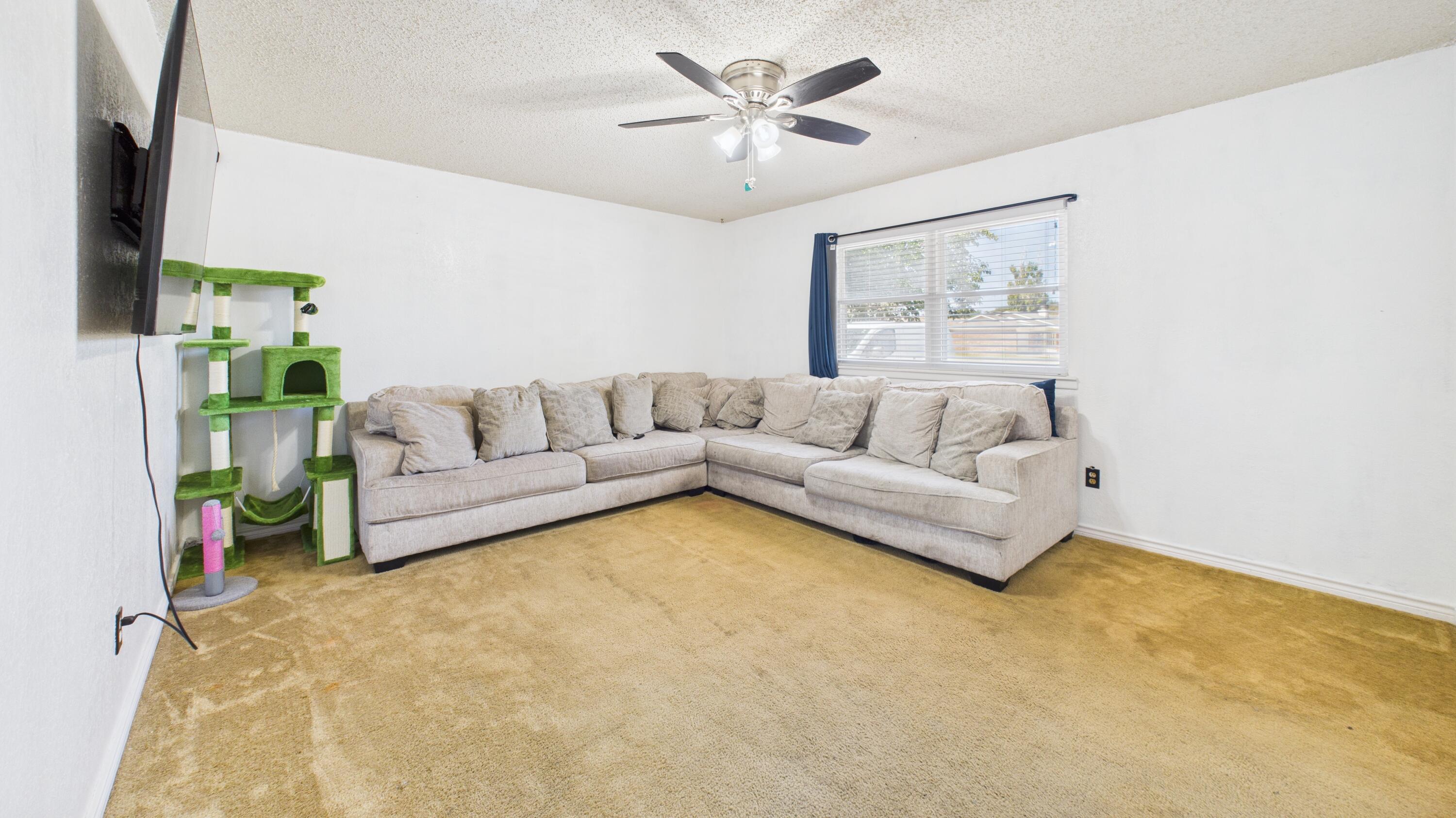 5431 34th Street Lubbock, TX 79407 - Photo 6 of 22 a living room with furniture and a couch