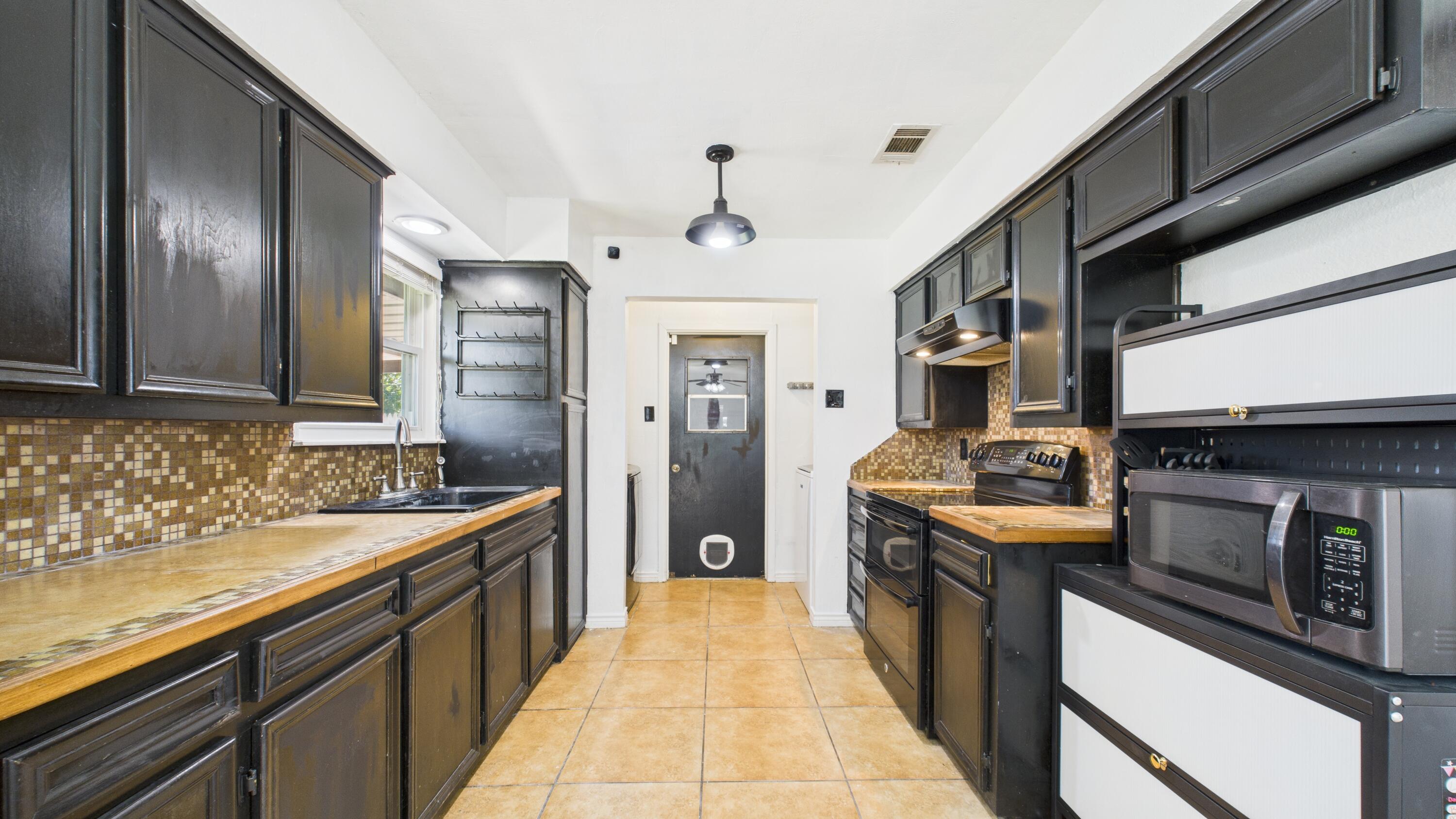 5431 34th Street Lubbock, TX 79407 - Photo 7 of 22 a kitchen with stainless steel appliances granite countertop a stove and a sink