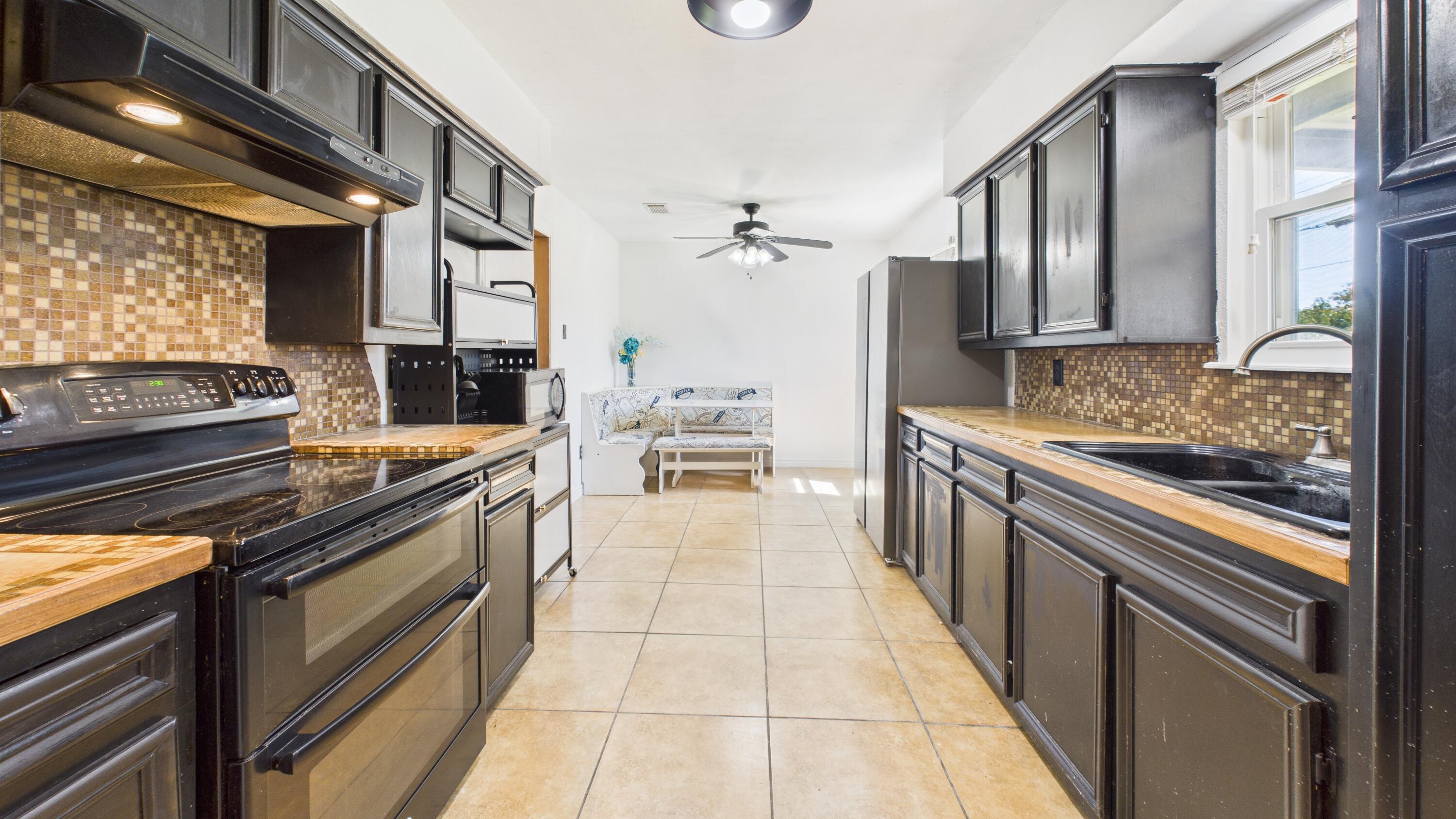 5431 34th Street Lubbock, TX 79407 - Photo 8 of 22 a kitchen with stainless steel appliances granite countertop a stove and a refrigerator