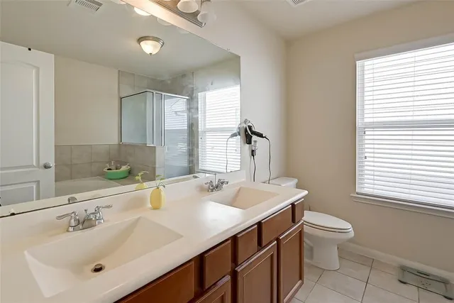 a bathroom with a sink toilet and shower