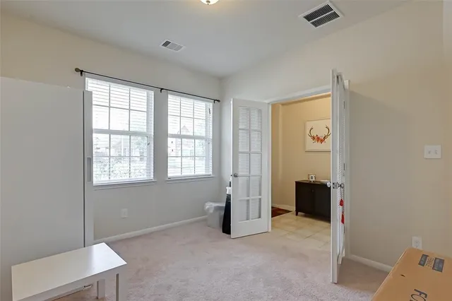 a living room with furniture kitchen view and a chandelier