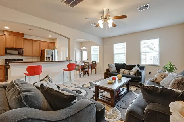 a kitchen with stainless steel appliances granite countertop a refrigerator stove and sink