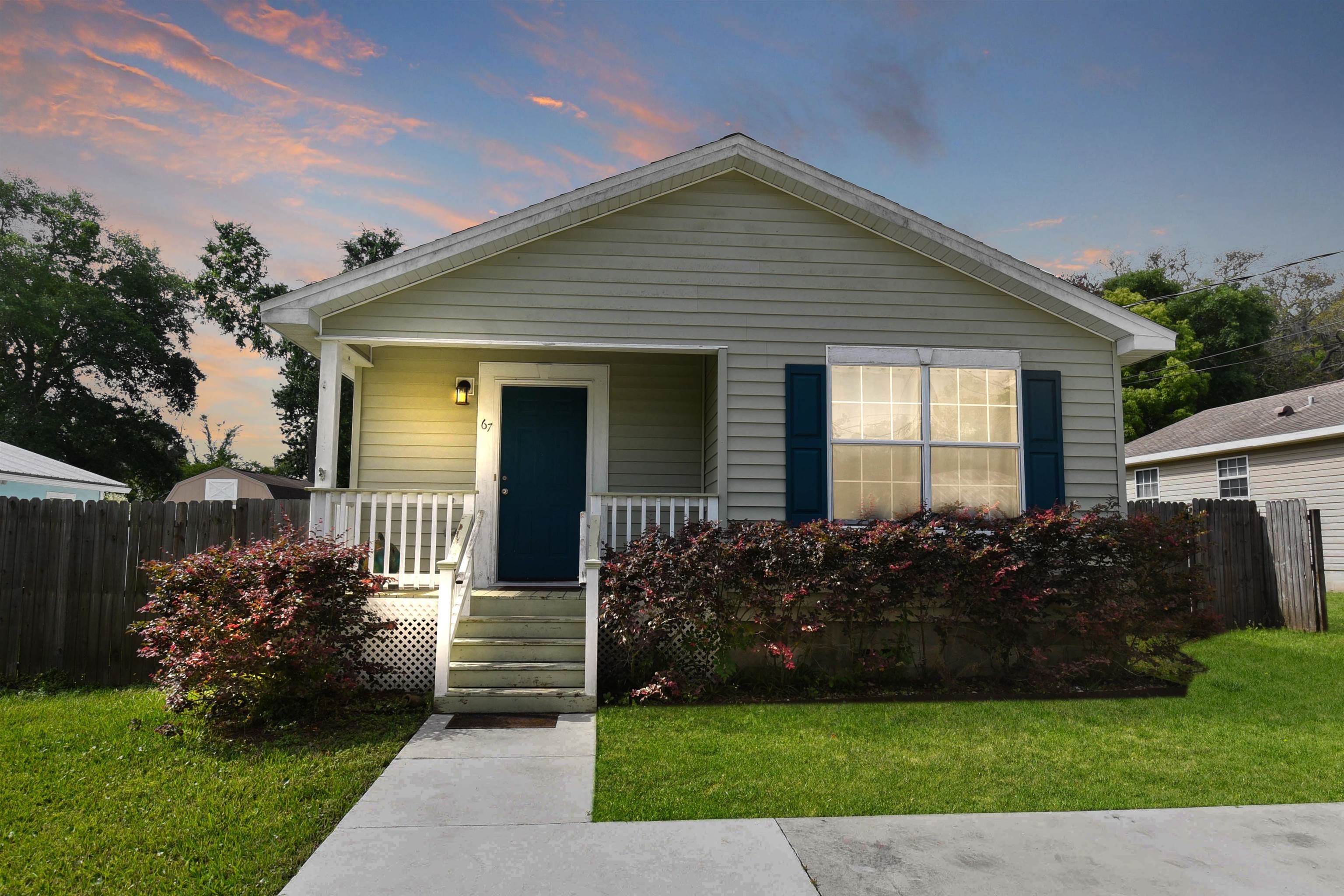 a front view of a house with a garden