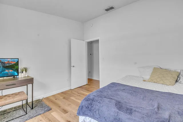 a bedroom with a bed and a table